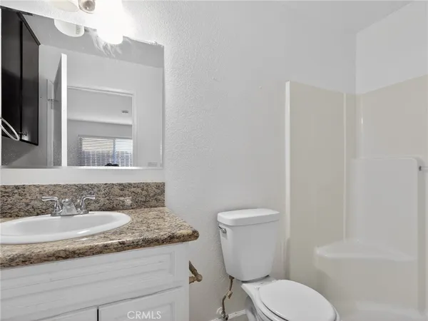 a white toilet sitting next to a bathroom sink