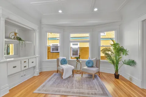 a view of a dining room with furniture and a window