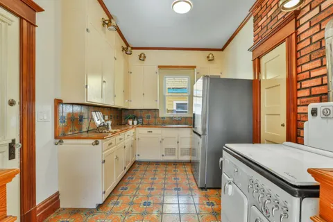 a kitchen with stainless steel appliances granite countertop a refrigerator and a sink