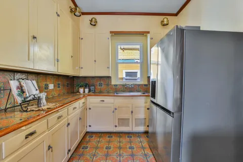 a kitchen with a refrigerator and a stove