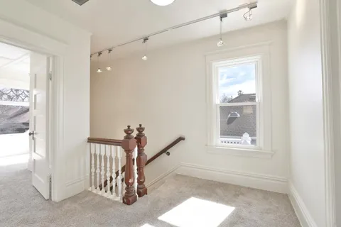 a bedroom with a bed ceiling fan and a window