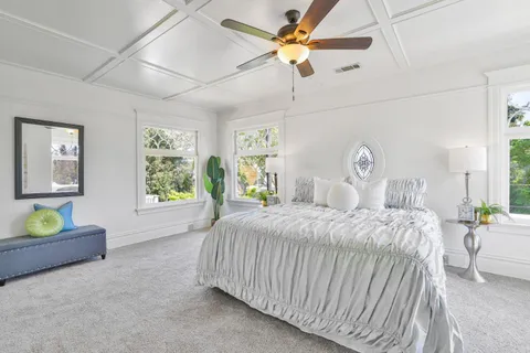a spacious bedroom with a bed and a large window