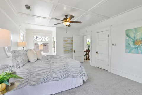 a bedroom with furniture and a fan