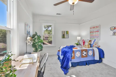 a bedroom with a bed and a chandelier