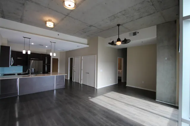 a view of a kitchen with a sink and a refrigerator