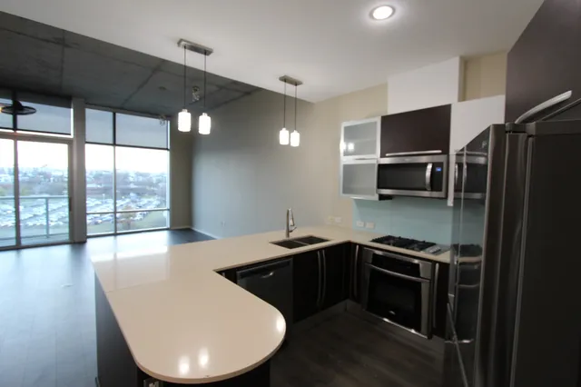 a kitchen with stainless steel appliances a stove sink and microwave