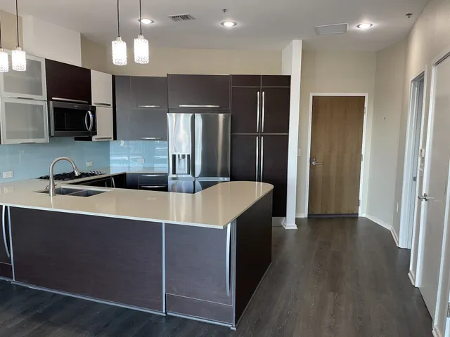 a kitchen with stainless steel appliances a refrigerator and a sink