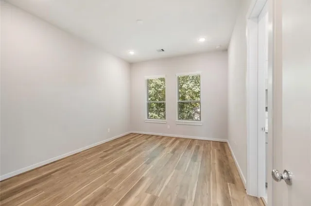 wooden floor in an empty room with a window