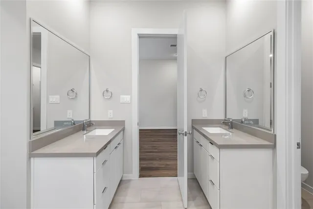 a bathroom with a tub sink and mirror