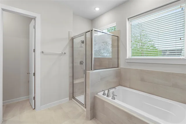 a bathroom with a bathtub and a shower