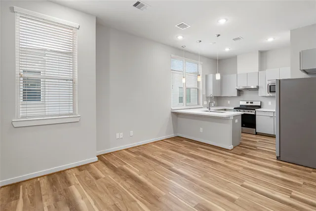 a kitchen with a refrigerator and a sink