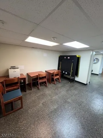 a living room with furniture and a mirror