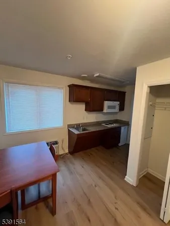 a room with furniture pool table and wooden floor