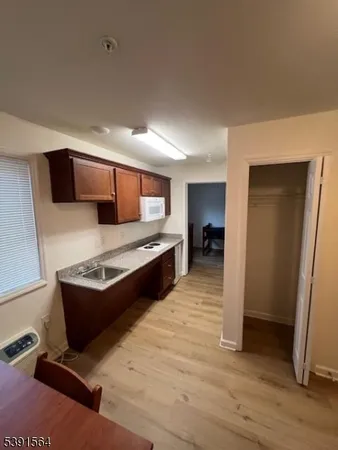 a large kitchen with stainless steel appliances granite countertop a stove and a refrigerator