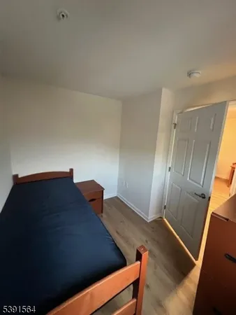 a view of an empty room and wooden floor