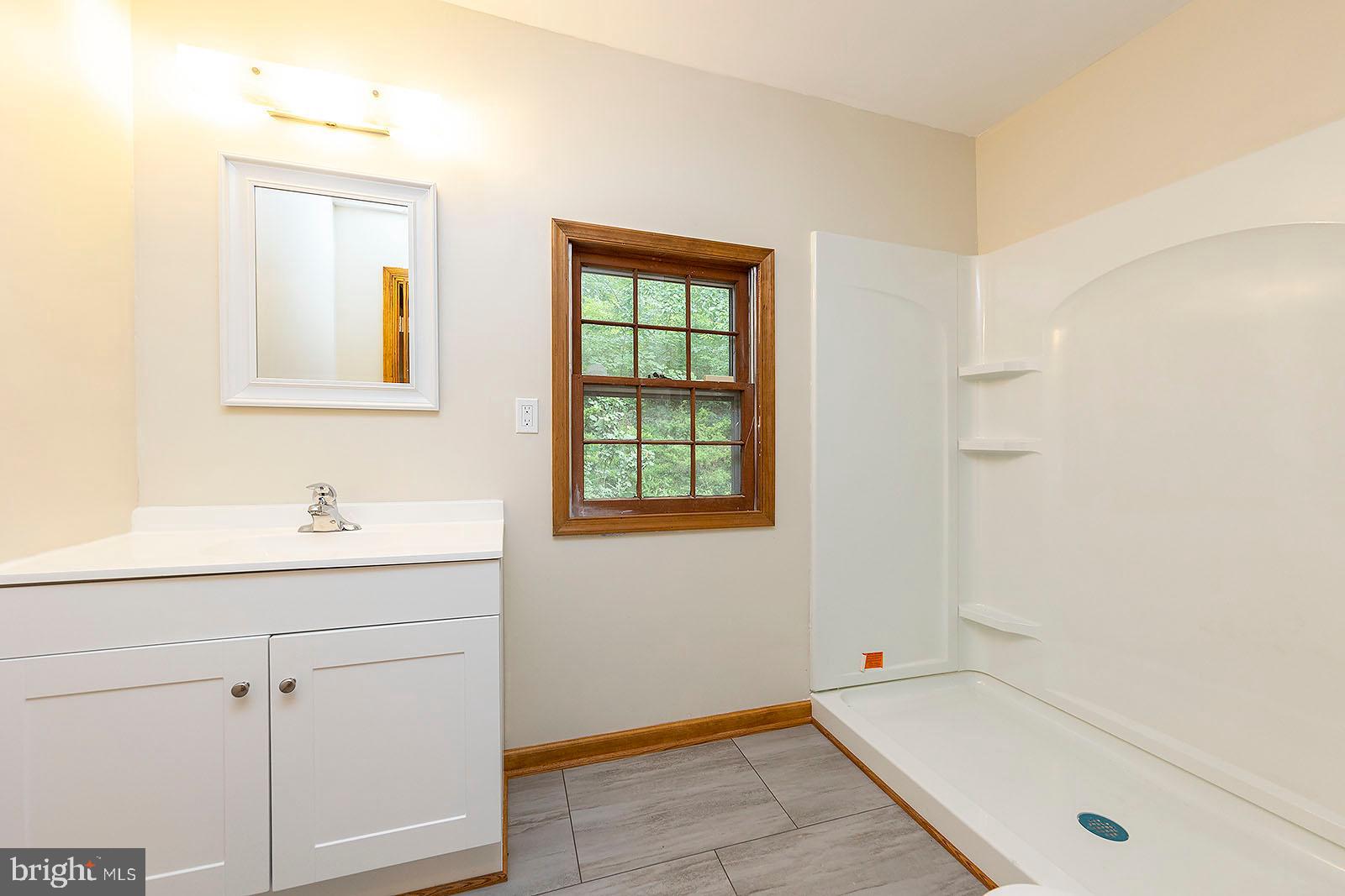 114 Inca Trail Winchester, VA 22602 - Photo 15 of 44 a bathroom with a tub sink and mirror