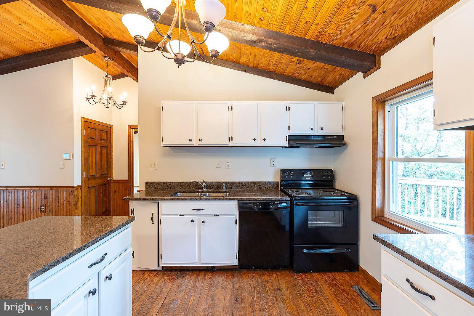 114 Inca Trail Winchester, VA 22602 - Photo 32 of 44 a kitchen with stainless steel appliances granite countertop wooden floors a stove and a microwave