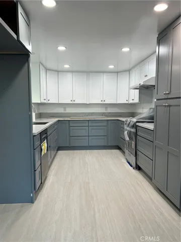 a large kitchen with wooden cabinets and stainless steel appliances