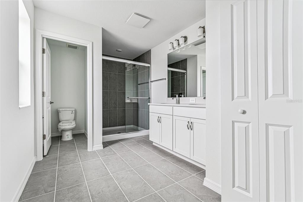 9106 Optimist Way Palmetto, FL 34221 - Photo 13 of 28 a bathroom with a sink a toilet and shower