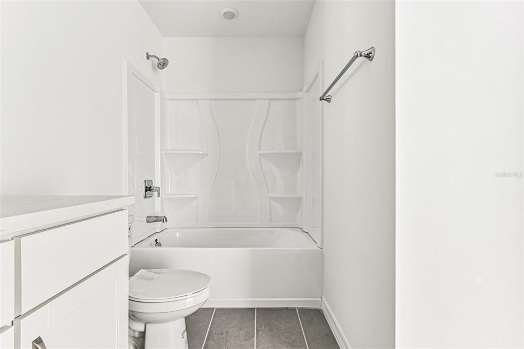 9106 Optimist Way Palmetto, FL 34221 - Photo 21 of 28 a bathroom with a sink a toilet and shower