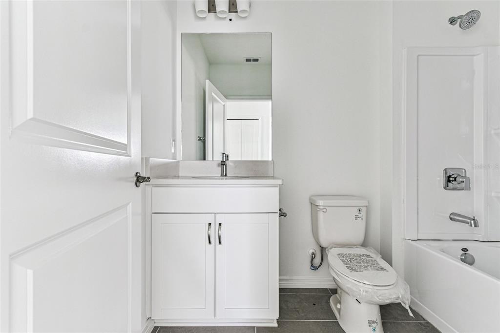9106 Optimist Way Palmetto, FL 34221 - Photo 27 of 28 a bathroom with a toilet sink and tub