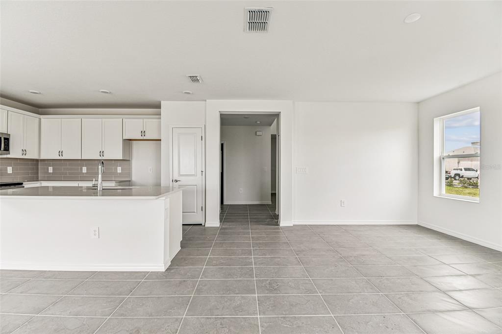 9106 Optimist Way Palmetto, FL 34221 - Photo 7 of 28 a view of kitchen with granite countertop lots of white cabinets
