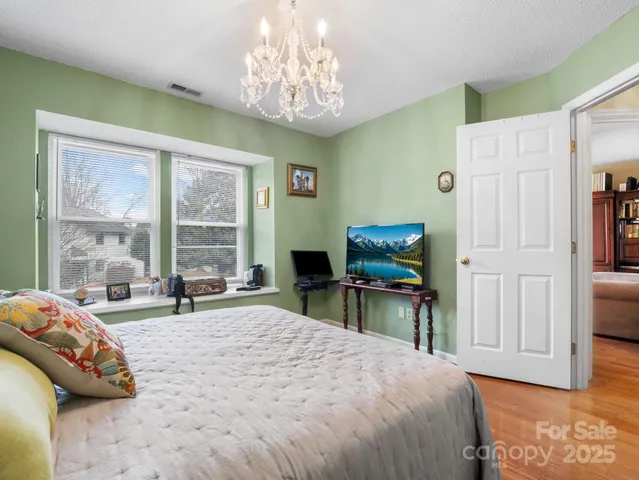 a bedroom with a bed and a chair