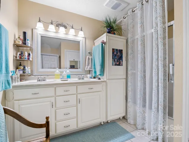 a bathroom with a sink vanity and mirror