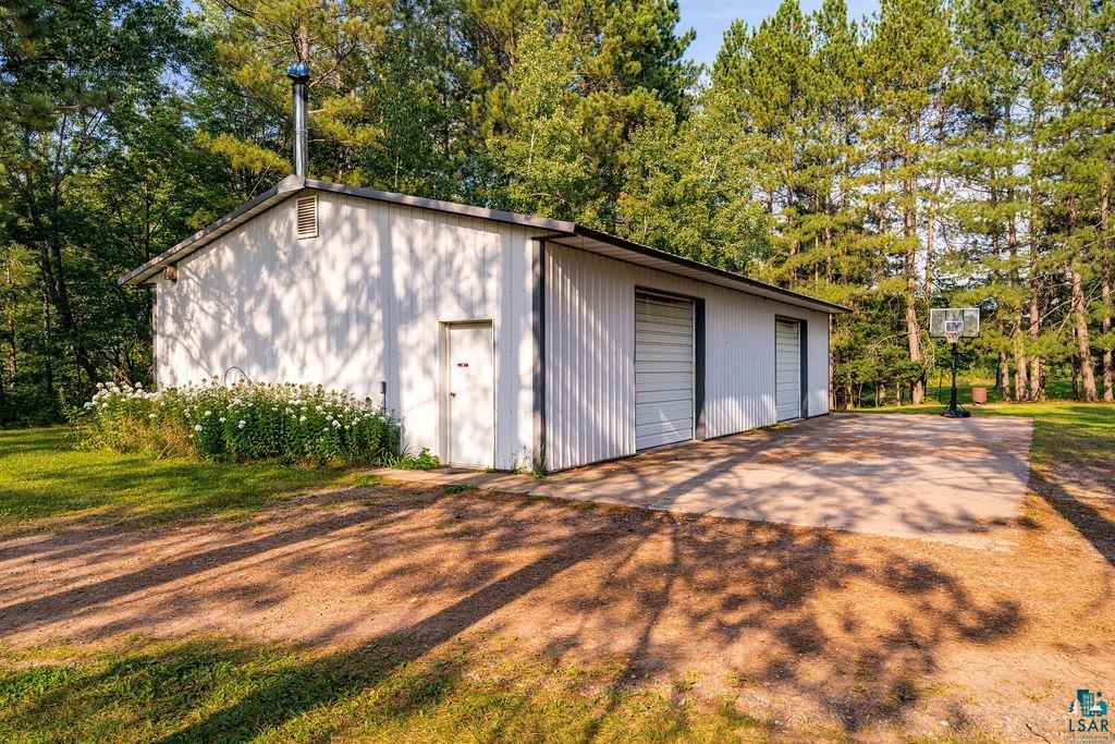 3168 Pioneer Road Barnum, MN 55707 - Photo 45 of 46 This outbuilding is closer to the house and is also heated. Great space for overflow vehicles. It also houses a wood boiler for the home.