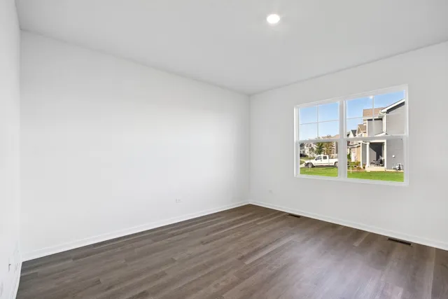 a kitchen with a table chairs refrigerator and microwave