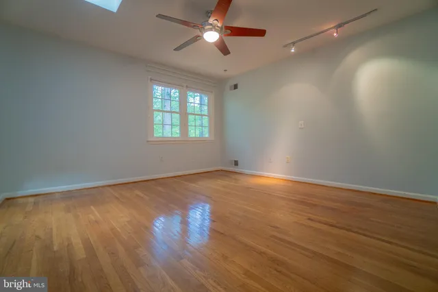 a bathroom with a sink a toilet a mirror and window