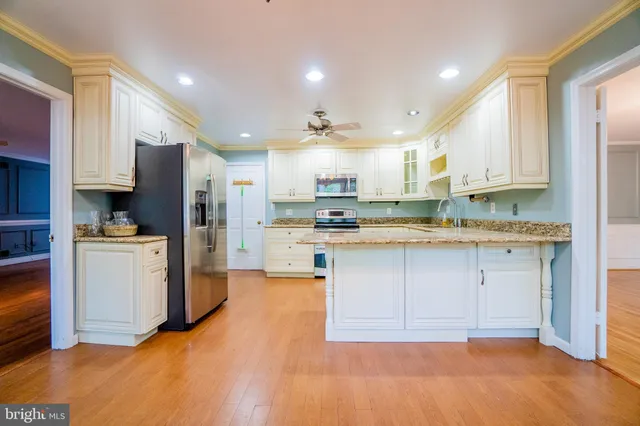 a kitchen with refrigerator and cabinets