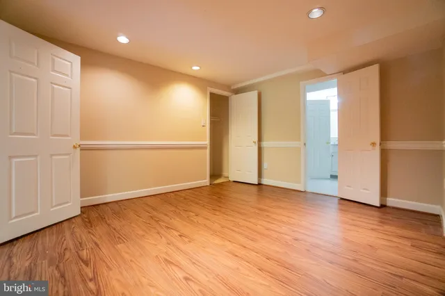 a bathroom with a granite countertop toilet sink and mirror