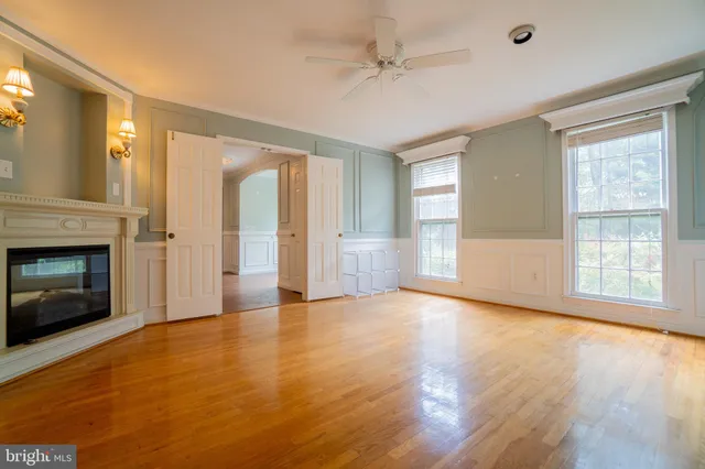 a view of an empty room with window and fire place