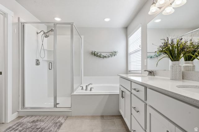3244 West 1670th Street North Provo, UT 84601 - Photo 30 of 56 Bathroom featuring a separate walk-in shower with glass enclosure, soaking tub, and dual sink vanity with light-colored countertops