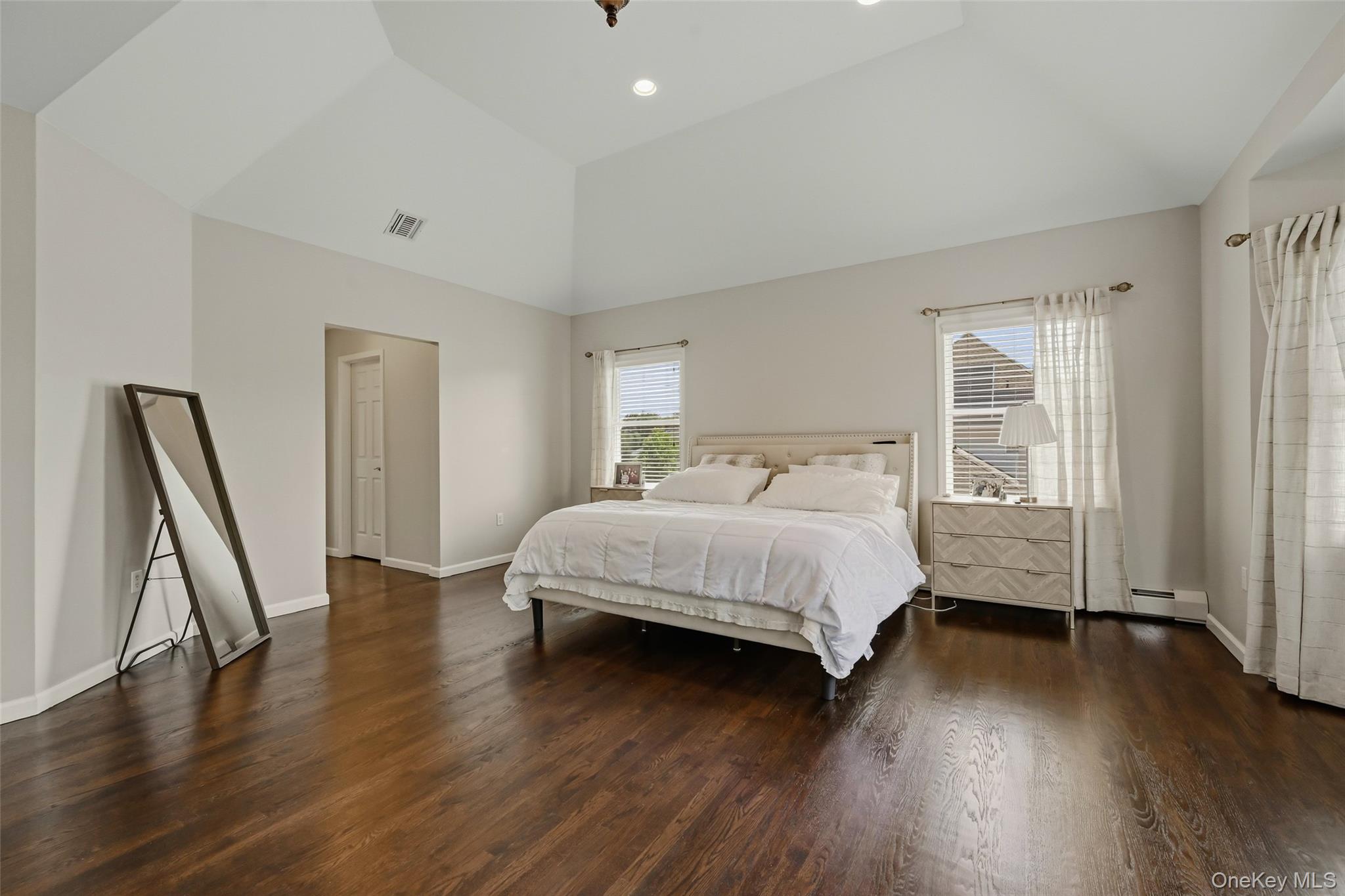 51 Meriwether Trail Congers, NY 10920 - Photo 24 of 50 Spacious room featuring vaulted ceilings with recessed lighting, dark wood-finish flooring, and light-toned walls