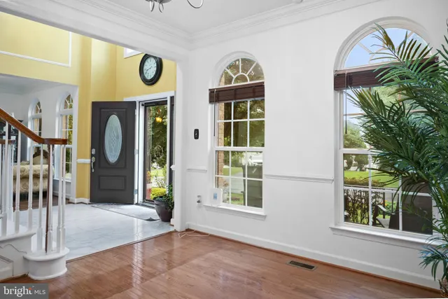 a kitchen with stainless steel appliances granite countertop wooden cabinets a sink and a large window
