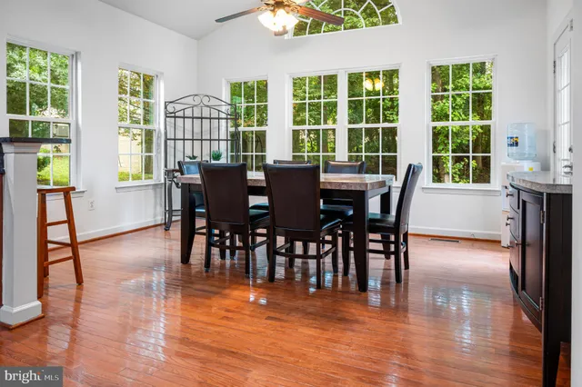 a view of a livingroom with a hardwood floor and a ceiling fan