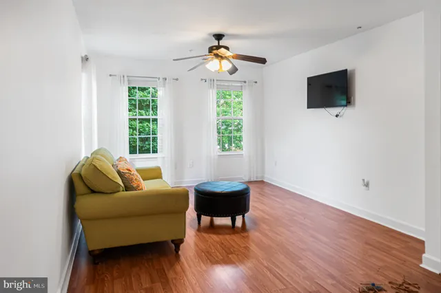 a view of an empty room with wooden floor