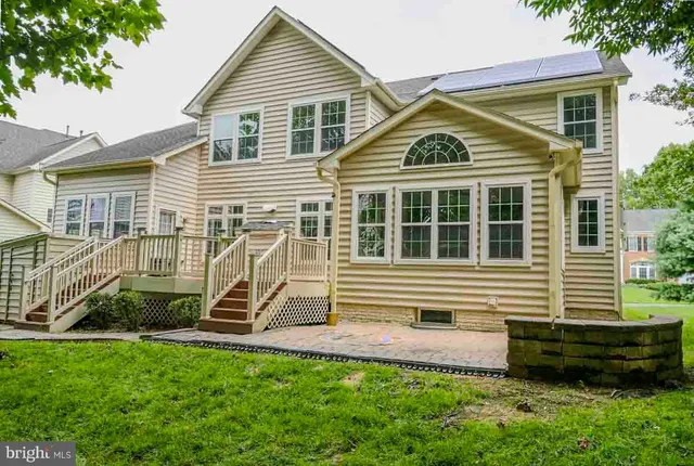 a view of an entryway with wooden floor windows and a chandelier