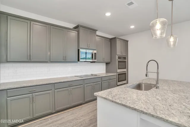 a kitchen with sink cabinets and microwave