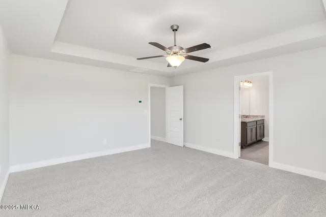 a view of an empty room with a ceiling fan
