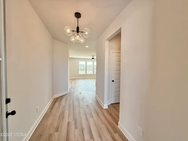 an empty room with wooden floor and closet