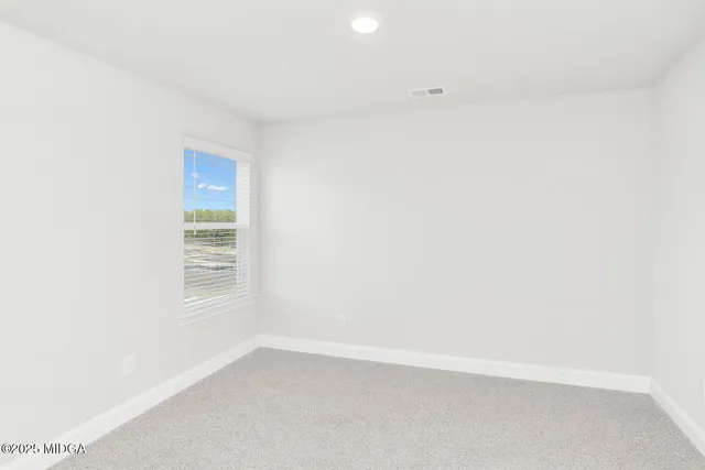 a view of an empty room and a window