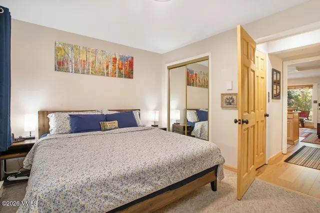 a bedroom with a large bed and a chandelier