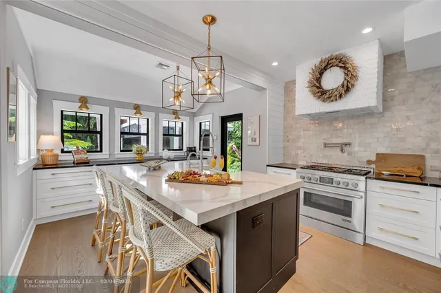 a kitchen with sink refrigerator and window