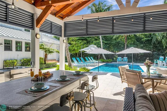 a view of a patio with table and chairs potted plants with wooden floor and fence