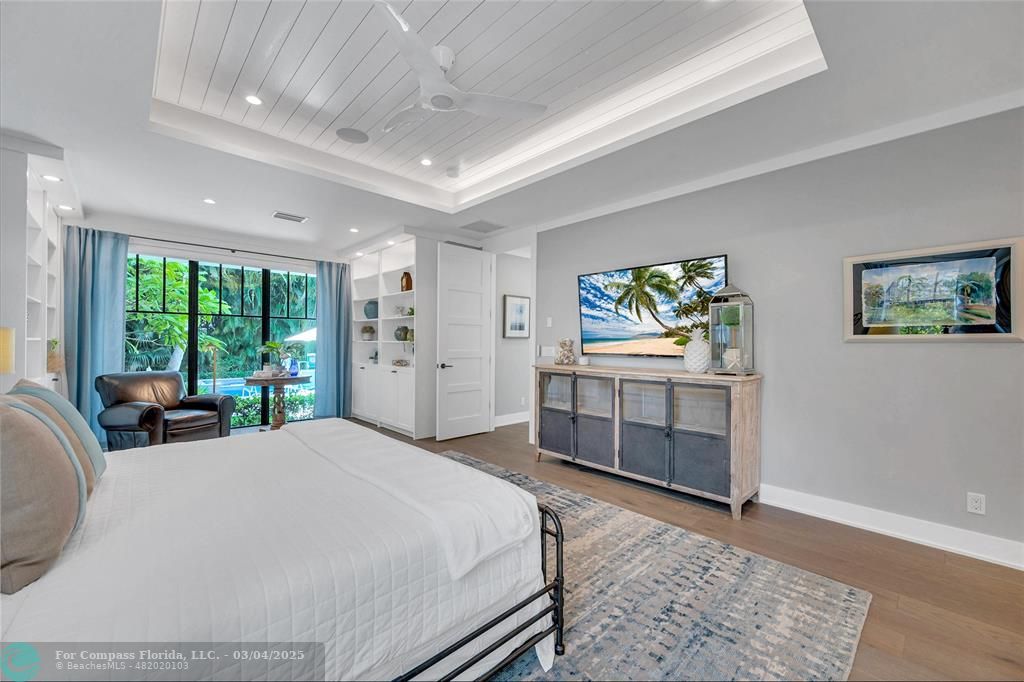 450 North Swinton Avenue Delray Beach, FL 33444 - Photo 26 of 43 a large bedroom with a bed and a dresser next to a window