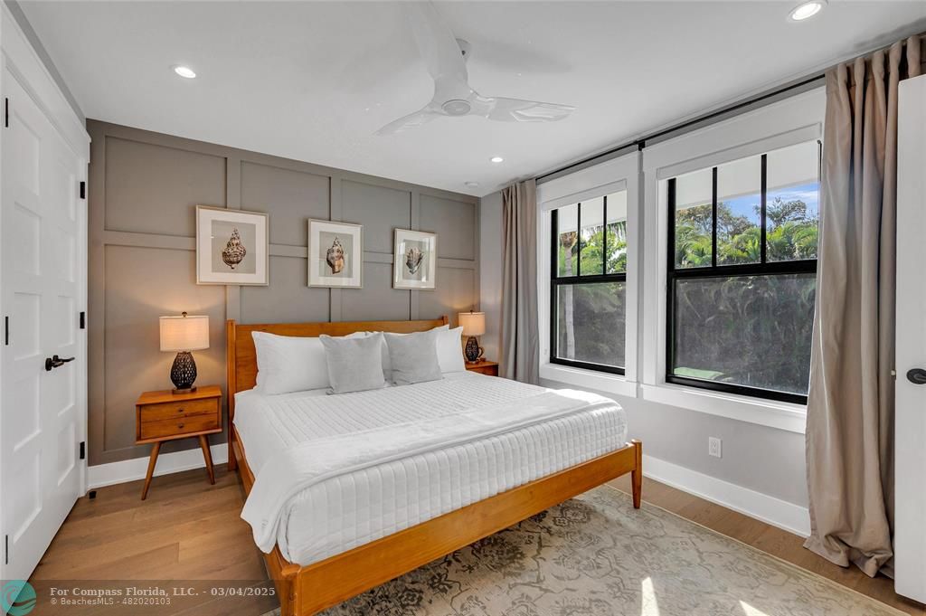 450 North Swinton Avenue Delray Beach, FL 33444 - Photo 31 of 43 a bedroom with a bed and a large window