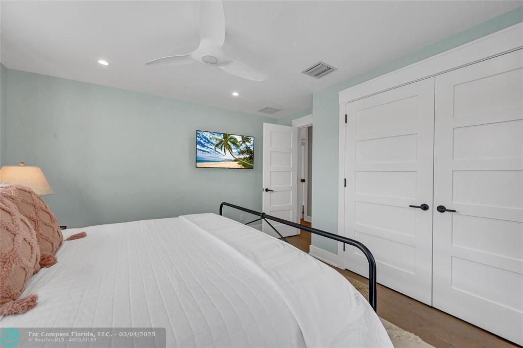 450 North Swinton Avenue Delray Beach, FL 33444 - Photo 35 of 43 a bedroom with a bed and a painting on the wall
